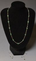 A contemporary modern design emerald green stone inset white gold necklace and earring suite,