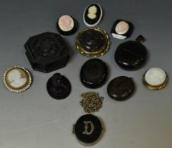 Jewellery - a Victorian black jet locket pendant, others similar, a brooches.