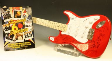 A Rockburn guitar signed by 1960's artists including Herman's Hermits, The swinging Blue Jeans, etc,