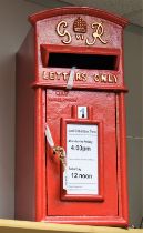 A reproduction cast metal George IV post box