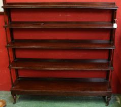 A 19th century mahogany five-tier waterfall bookcase, turned columns, brass casters, 116cm high,