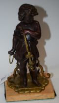 French School, a parcel-gilt and dark patinated bronze, of a young girl holding a flowering branch,