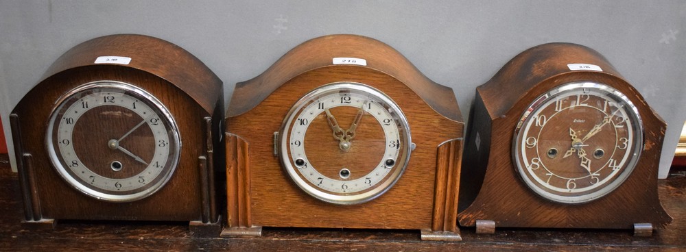 A Smiths Enfield oak arched mantel clock, circular chrome dial, Arabic numerals, twin winding holes,