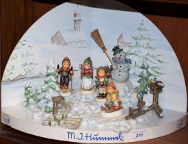 A Hummel Goebel Christmas advertising window display stand and figures, including Snowman, Skier,