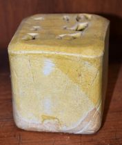 A salt glazed stoneware cube vase, by Eileen Lowenstein, of folded form, glazed throughout in ochre,