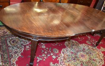 An early 20th century mahogany extending dining table, discorectangular top,