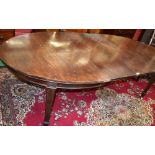 An early 20th century mahogany extending dining table, discorectangular top,