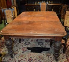 A Victorian mahogany extending dining table, rounded rectangular top,