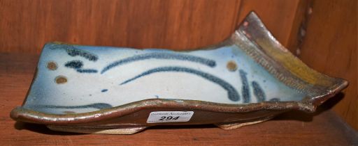 A salt glazed stoneware asymmetrical curved rectangular dish, by Jim Robison,