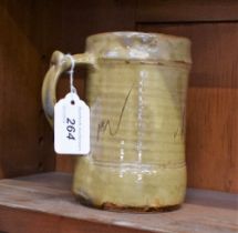 A Wenford Bridge ribbed cylindrical mug, by Danlami Aliyu, slip glazed in mottled olive green,