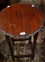 An early-mid 20th century oak occasional table, shaped circular top, spirally turned supports, 72.