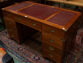 A contemporary campaign style twin pedestal writing desk,