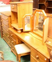 A contemporary pine dressing table and stool; a similar chest of five long drawers;