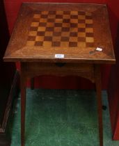 An Arts and Crafts game table,