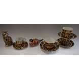 A set of three Royal Crown Derby 1128 pattern tea cups and saucers,