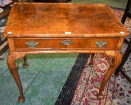 A George II Revival walnut silver table, dished rectangular top above a long frieze drawer,