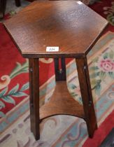 An Arts and Crafts oak occasional table, hexagonal top, pierced outswept legs,