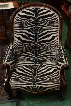 A Victorian mahogany framed nursing chair, button back, scroll arms, cabriole legs, scroll forefeet,