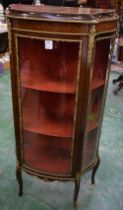 A Louis XVI style gilt metal and mahogany bow fronted display cabinet,