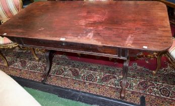 A Regency mahogany library table, rounded rectangular top above a frieze drawer, turned stretcher,