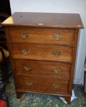 An early-mid 20th century oak chest of four long drawers, bracket feet,