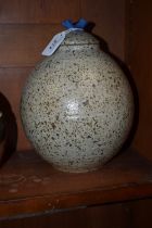 A stoneware ovoid vase and cover, by Helen Walters, speckled glazed in brown on an oatmeal ground,