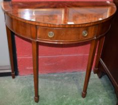 A George III style mahogany demi-lune side table, slightly oversailing top above a frieze drawer,