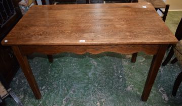 An early 20th century oak centre table, rectangular top above a shaped freeze,