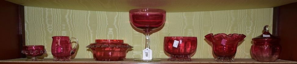 A quantity of late 19th century and later cranberry glass, including lidded jar, footed bowl,