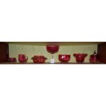 A quantity of late 19th century and later cranberry glass, including lidded jar, footed bowl,