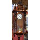 A mahogany cased Vienna type wall clock, architectural pediment crested by an eagle,