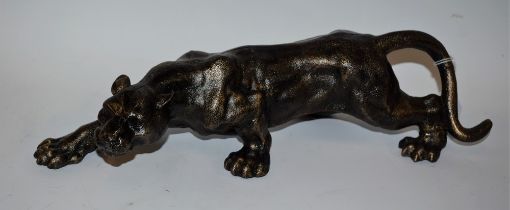 A reproduction cast metal figure, as a lioness stalking,