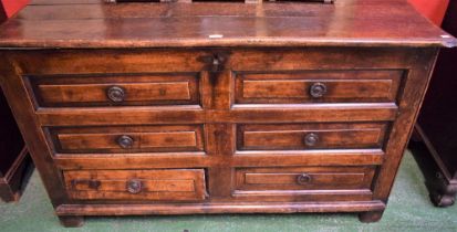 An early 18th century oak Lancashire type mule chest, hinged top above four blind drawers,