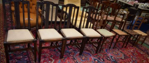 A set of four early 20th century oak dining chairs; others, cane seat,