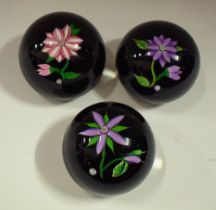 A set of three John Deacons 'J Glass' paperweights,