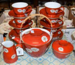 A Noritake tea service, decorated with Chrysanthemums on an orange ground,