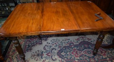 A Victorian design extending dining table, rounded rectangular top with additional leaf,