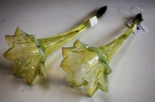 A pair of uranium glass bud vase, arms, moulded bowls, tapering shafts, each approx 24cm long,