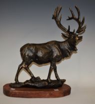 A reproduction cast metal figure, of a stag, plinth base, 48.