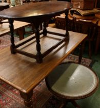 A contemporary 'oak' effect dining table; an oak eliptical coffee table;