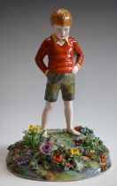 A Crown Staffordshire ceramic figure, Boy in Flower Meadow, modelled by T.