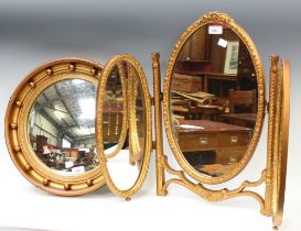 A gilt framed bulls eye wall mirror; another,