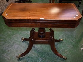 A Regency mahogany card table, crossbanded top enclosing a baize lined playing surface,