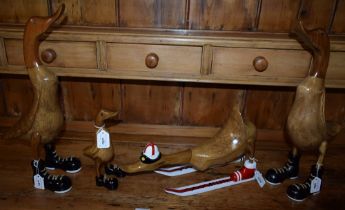 A pair of wooden models, boot sporting ducks; another, smaller; another,