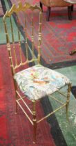 A brass chair, arched crest, spindle back,