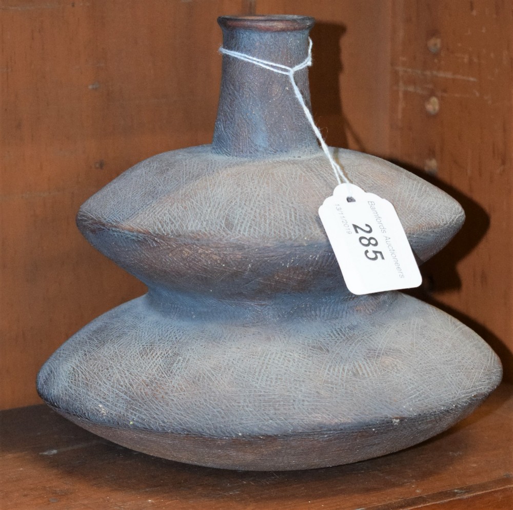 A stoneware double gourd bottle vase, in the manner of Hans Coper, slip glazed in brown,