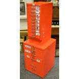 A red four drawer filing cabinet;