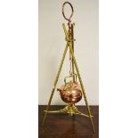 An Arts and Crafts copper and brass spirit kettle, stand and burner, in the manner of W A S Benson,