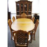 An American antiqued oak dining suite comprising display sideboard,