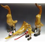 A pair of wooden models, boot sporting ducks; another, smaller; another,
